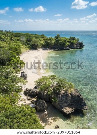 A small coral beach surrounded by rocky outcrops in Laiya, San Juan, Batangas, Phillipines.