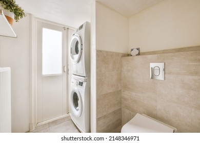 A Small Corner For A Laundry Room With Washing And Drying Machines In A Cozy Residential Apartment