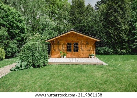 Small cottage in the countryside. Garden house made of wood. Cottage in your own garden for hobbies and free time during the pandemic. Shed in a large garden in Germany 