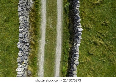 Small country road between stone wall. Inishmore, Aran islands, county Galway, Ireland. Top down aerial view - Powered by Shutterstock