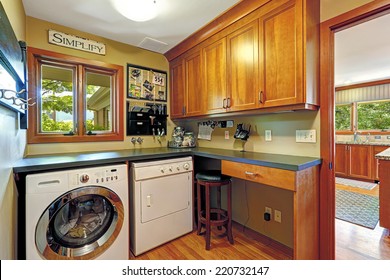 Small Craft Room With Wooden Storage Combinatation And Laundry Appliances