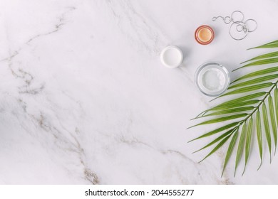 Small Cream Bottles With Woman's Jewelry Palm Tree Leaf - Beauty And Spa Concept Flat Lay