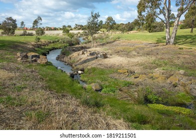 A small creek/waterway in a large public park. Australian nature landscape. Hoppers Crossing Drain, Melbourne, VIC Australia.