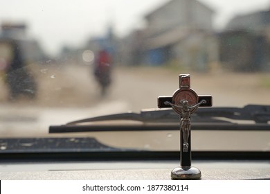 a small cross on the dashboard of the car to accompany the journey