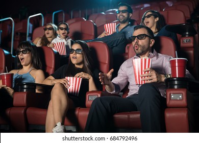 Small Crowd Of People Looking Really Surprised While Watching A 3d Film At The Movie Theater