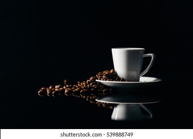 Small Cup Of Black Coffee On A Dark Background With Coffee Beans