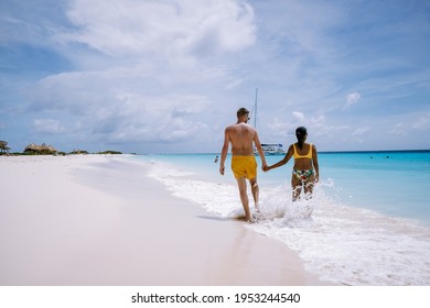 Small Curacao Island Famous For Day Trips And Snorkeling Tours On White Beaches Blue Clear Ocean, Curacao Island In The Caribbean Sea. A Couple Of Men And Woman On The Beach During A Vacation Holiday