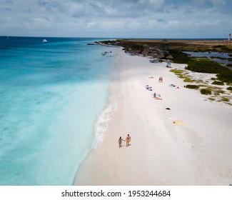 Small Curacao Island Famous For Day Trips And Snorkeling Tours On White Beaches Blue Clear Ocean, Curacao Island In The Caribbean Sea. A Couple Of Men And Woman On The Beach During A Vacation Holiday