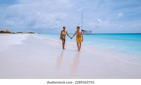 Small Curacao Island famous for day trips and snorkeling tours on white beaches and blue clear ocean, Curacao Island in the Caribbean sea. a couple of men and woman on the beach during a vacation  - Powered by Shutterstock