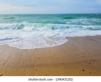 Small Curling Wave On Sandy New England Beach