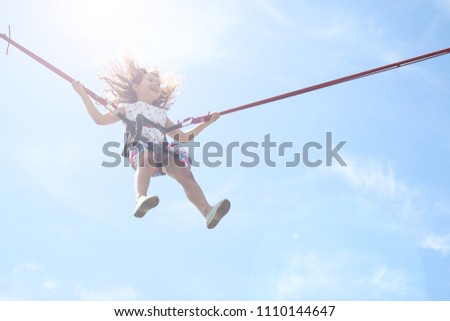 Similar – Image, Stock Photo Bungee jumping at trampoline. Little girl bouncing on bungee jumping in amusement park on summer vacations