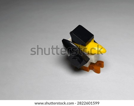 a small custom bird figure built out of colorful plastic Lego bricks on a plain white surface.