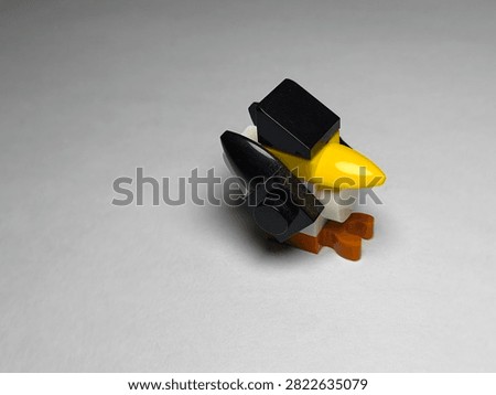 a small custom bird figure built out of colorful plastic Lego bricks on a plain white surface.