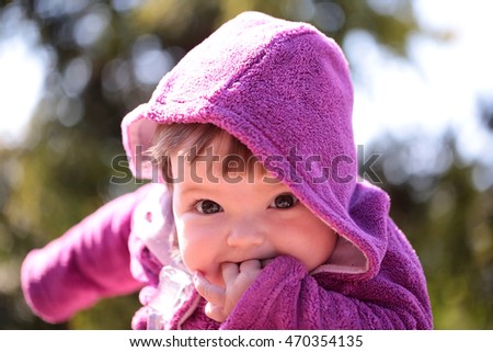 Similar – small girl wearing a hat singing happily