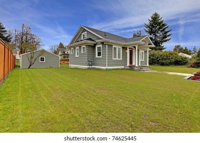 Small Cute Grey New England Style Home With Matching Detached Garage.