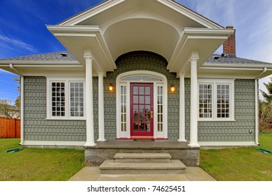 Small Cute Grey New England Style Home With Pink Red Door.