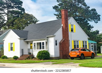 Small, Cute House In A Small American Town Near The Ocean. Well-groomed Lawn And Blue Sky.