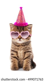 Small cute kitten in pink heart-shaped sunglasses and party hat isolated on white