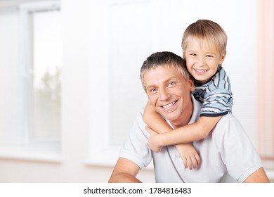 Small cute son sit on strong dad shoulders - Shutterstock ID 1784816483