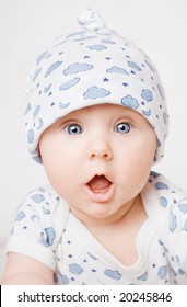 Small cute surprised child in blue pajama