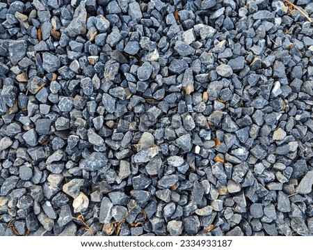 Small dark stones on rocky gravel pathway