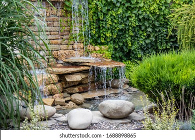 A small decorative waterfall in the garden. Landscape design