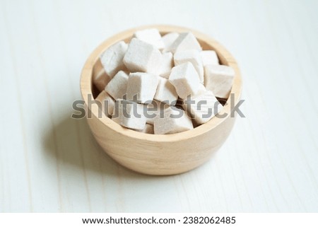 Small diced pieces of freeze-dried chicken breast, preserved for use as pet treats