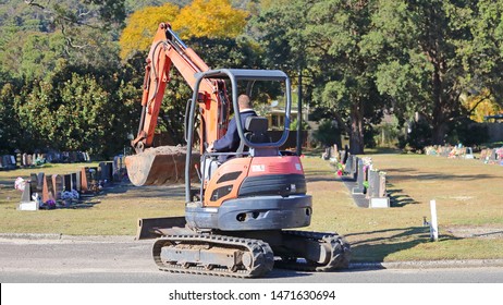 Small Digger Excavator In A Graveyard