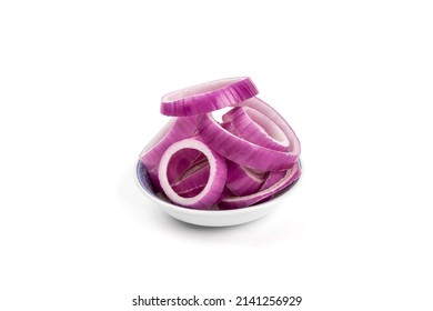 a small dish of Slices of a red cooking onions cut into rings isolated on white