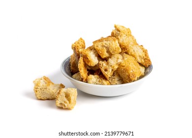 A Small Dish Of Toasted Seasoned Garlic And Parmesan Soup Or Salad Croutons Isolated On White