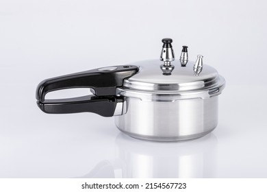 Small Double Valve Pressure Cooker On Neutral Background.