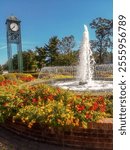 Small downtown city square with clock tower and water fountain