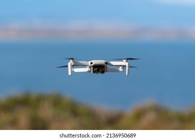 Small Drone Flying Still With A Defocused Sea Background