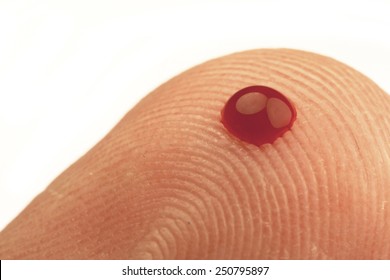 Small Drop Of Blood On The Tip Of A Finger