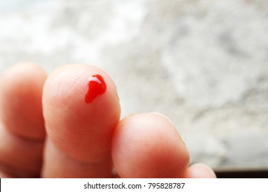 Small Drop Of Red Blood On Finger..