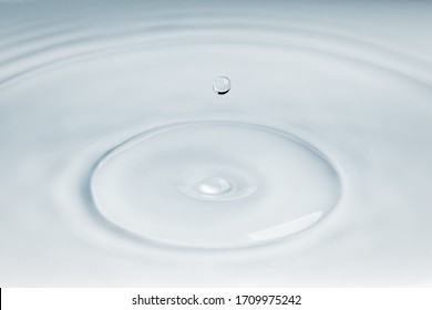 Small Droplet Of Water Falling Over Some Ripple Effect On The Surface Of Water