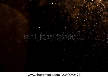 small drops of rain, snow on a black background. wind. Natural background. golden