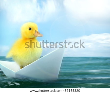 small duck  travelling by origami paper boat floating in a sea