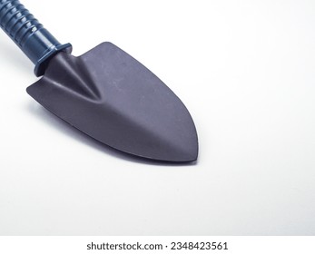 Small earthen shovel isolated on a white background, this shovel is suitable for gardening