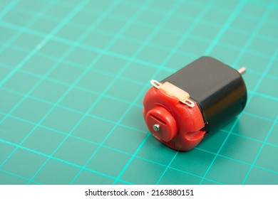 Small Electric Motor On Green Background.