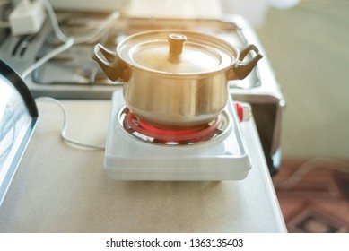 Small Electric Stove For Cooking. Portable Household Appliances. Food Prepared In The Home Kitchen When There Is No Gas