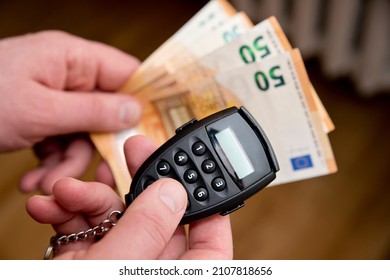 Small Electronic Password Generator Used For Banking Security On On Euro Banknotes. Saving Money Concept. Finance, Business, Investment. Spending Cash For Unexpected Expense.