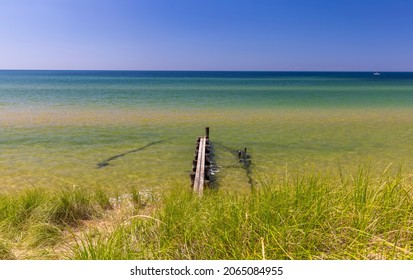 Small empty boating dock at lake Michigan shore , fresh Turquoise water in the lake