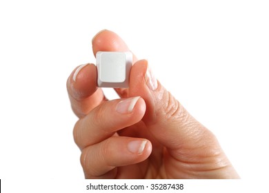 Small empty computerkeyboard key in hand, white background