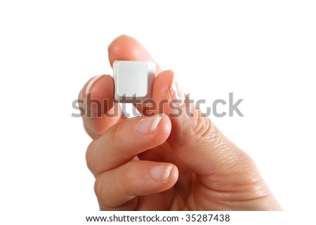 Small empty computerkeyboard key in hand, white background