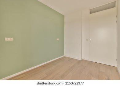 A Small Empty Room In A Modern House With One Green Wall