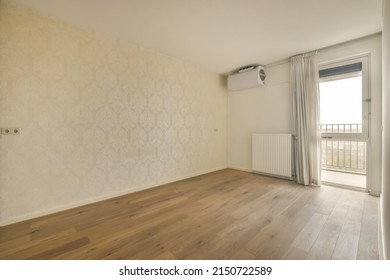 A Small Empty Room In A Modern House With A Big Window And A View Of The City