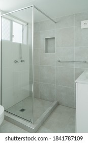 Small Ensuite Bathroom With Show Recess And Tiled Walls