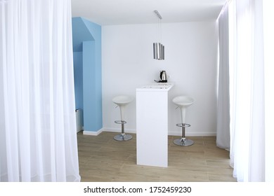 A Small Entrance Hall In Blue And White Tones In A Hotel Room. White Curtains In The Interior. Photos In The Interior Without People. Copy Space.