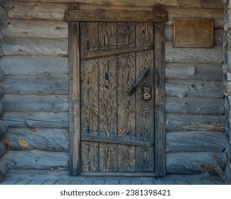small entrance wooden door of old traditional wooden log house. copy space.